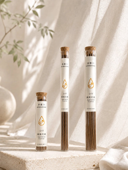Collection of agarwood incense tubes featuring 30-stick and 108-stick options with different burn times, displayed on a serene neutral background.