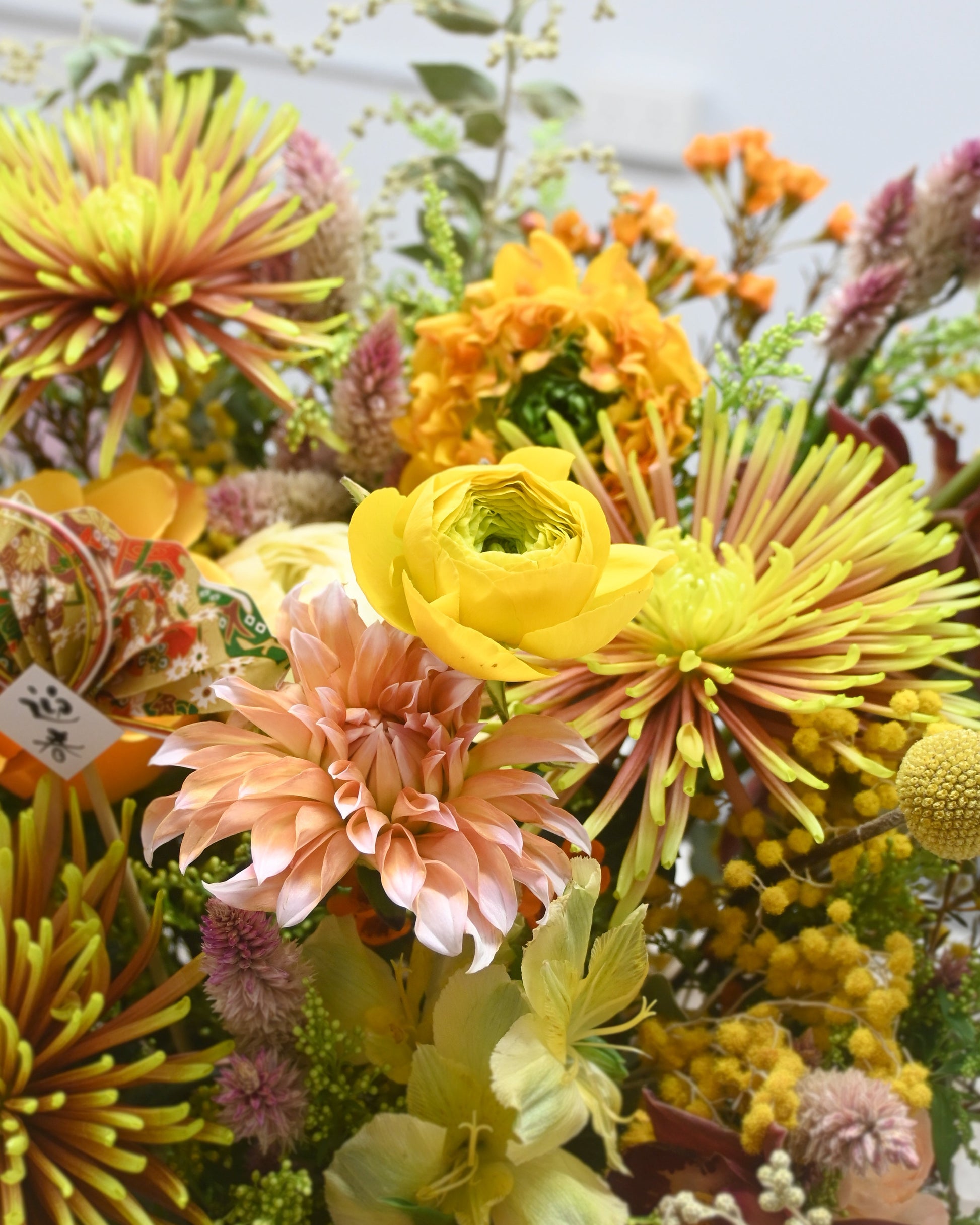黃色 roses、golden spider mums 及 apricot accents 的 flower close-up